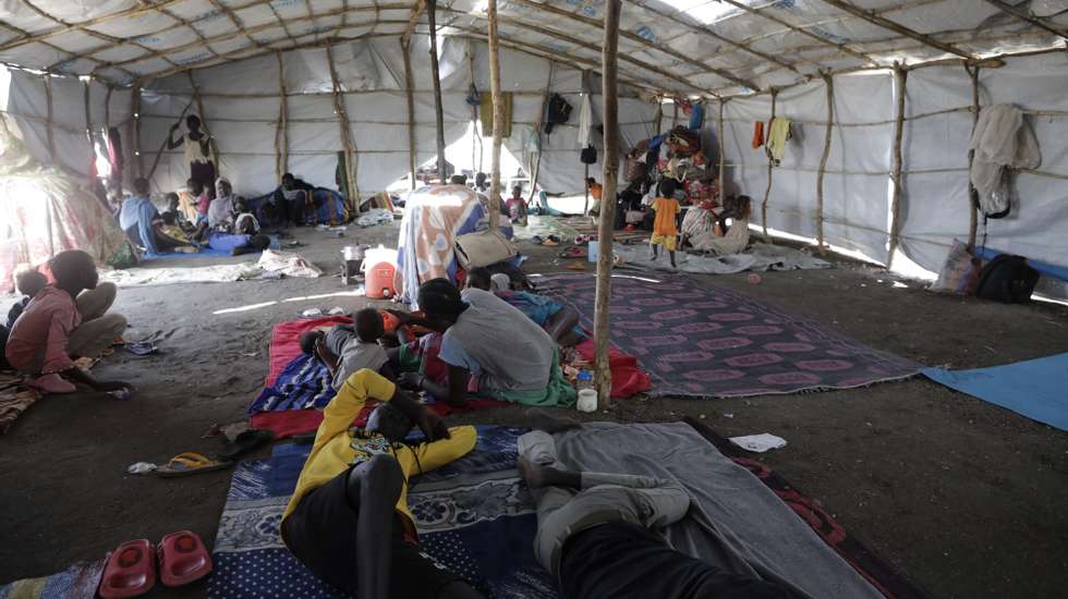 epa10629571 South Sudanese returnees take shelter from the heat and the strong sun inside one of the few covered areas at the transit area set up by the UNHCR in the Upper Nile State town of Renk, South Sudan, 15 May 2023. According to the United Nations, some 200,000 people have fled the conflict in Sudan between 15 April and 12 May 2023. Around 40.000 are in South Sudan, and about two million people were internally displaced. Leaving behind them the armed conflict between the Sudanese military and the RSF (Rapid Support Forces) militia which started one month ago today, most of the refugees in South Sudan are South Sudanese returnees, part of the some 800,000 who had previously fled the war in South Sudan and who are now returning to a country which is barely out of conflict itself, with tensions still remaining in many areas.  EPA/AMEL PAIN