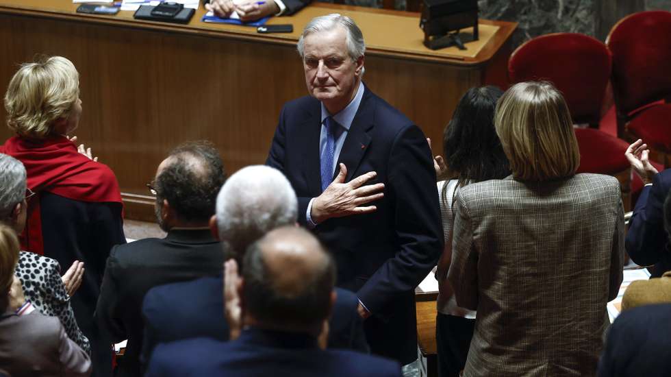 epa11757051 French Prime Minister Michel Barnier (C) gestures after delivering a speech during a no-confidence vote against his government at the National Assembly, in Paris, France, 04 December 2024. The no-confidence vote comes after the French prime minister activated Article 49.3 of the Constitution to pass his social security budget bill without a vote, as a majority of members of Parliament rejected his project on 02 December 2024.  EPA/YOAN VALAT