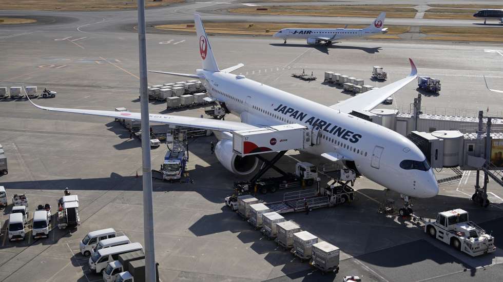 epa11236368 Japan Airlines aircrafts are parked on the tarmac at Tokyo's Haneda Airport in Tokyo, Japan, 22 March 2024. According to preliminary figures from the Ministry of Justice, the number of Japanese departing Japan in January 2024 was up 89.3 percent from the same month in 2023 but less 42.3 percent from 2019 due to a weaker yen.  EPA/FRANCK ROBICHON