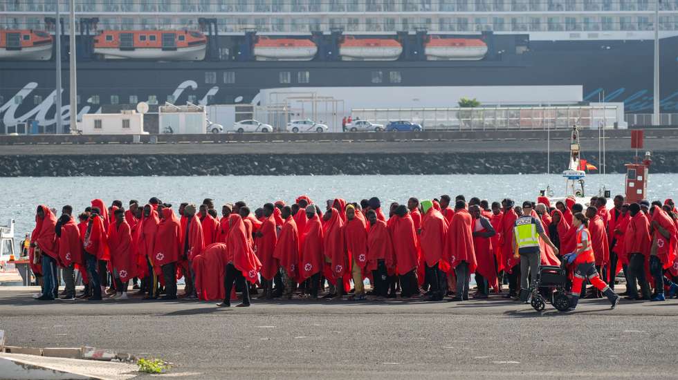 epa11796011 Red Cross members help some of the 240 migrants that have been rescued by Rescue Navy when they tried to reach the coast of Canary Islands by boats, at the docks in Arrecife, Lanzarote, Canary Islands, Spain, 28 December 2024.  EPA/ADRIEL PERDOMO