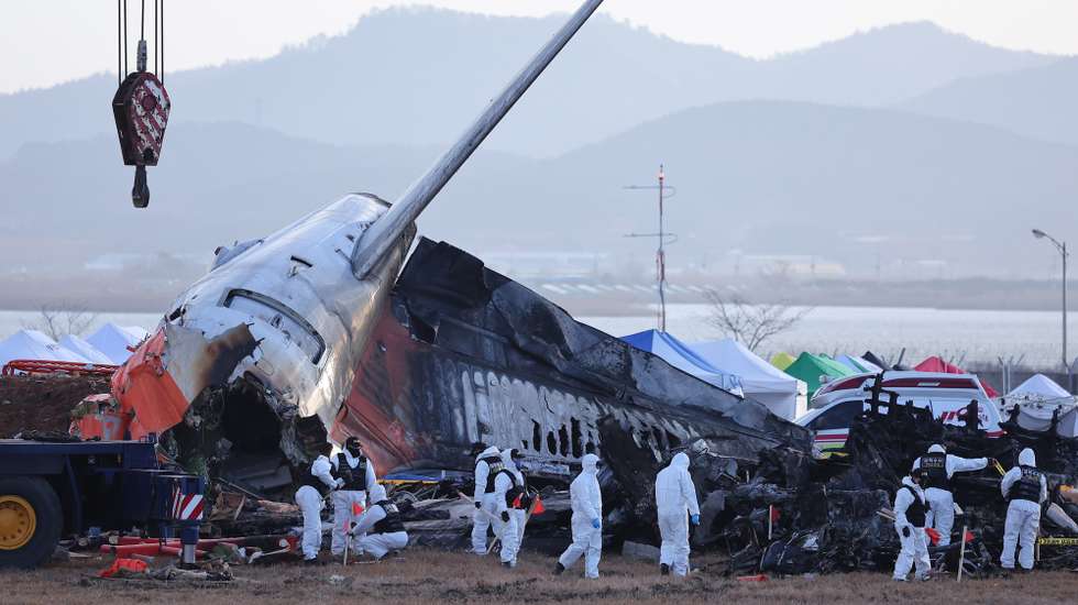 epa11799473 A police forensic team conducts an on-site investigation at the scene of the 29 December Jeju Air passenger plane crash at Muan International Airport in Muan, South Korea, 31 December 2024.  EPA/YONHAP SOUTH KOREA OUT