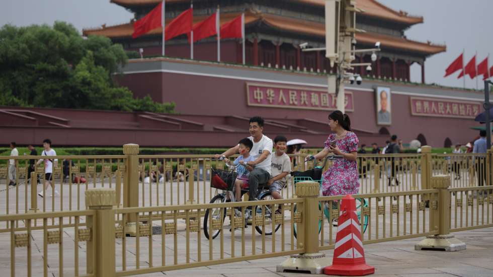 epa11479485 People ride a bicycle near Tiananmen Square as China's communist party holds its third plenum in Beijing, China, 15 July 2024. China, 15 July 2024. The third plenum of the Chinese Communist Party's central committee will be held in Beijing for four days, from 15 to 18 July 2024.  EPA/ANDRES MARTINEZ CASARES