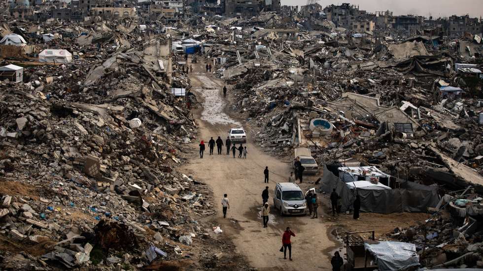 epaselect epa11952510 Palestinians walk among the rubble of their destroyed homes during the month of Ramadan, in the city of Beit Lahia, northern Gaza Strip, 09 March 2025.  EPA/HAITHAM IMAD
