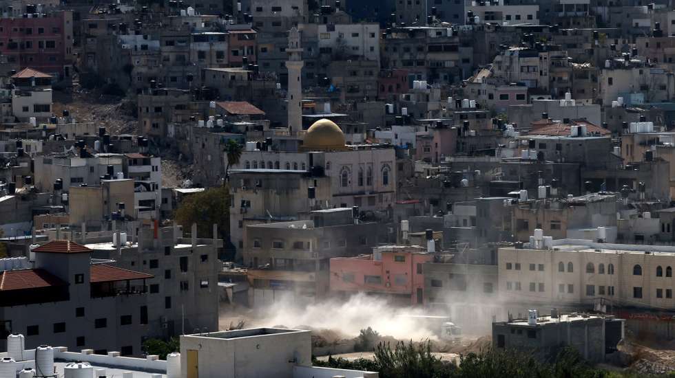 epa11960877 Smoke rises over the Nur Shams refugee camp during an Israeli military operation in the West Bank city of Tulkarem, 13 March 2025. According to the Palestinian news agency Wafa, the Israeli military continued its operation for the 46th consecutive day in Tulkarem.  EPA/ALAA BADARNEH