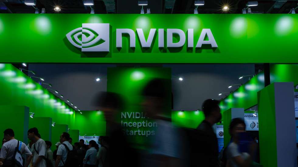 epa12118553 People walk past the NVIDIA booth during the COMPUTEX 2025 Exhibition show in Taipei, Taiwan, 20 May 2025. Computex 2025, one of the largest computer and technology trade shows in the world, runs from 20 to 23 May in Taipei.  EPA/RITCHIE B. TONGO