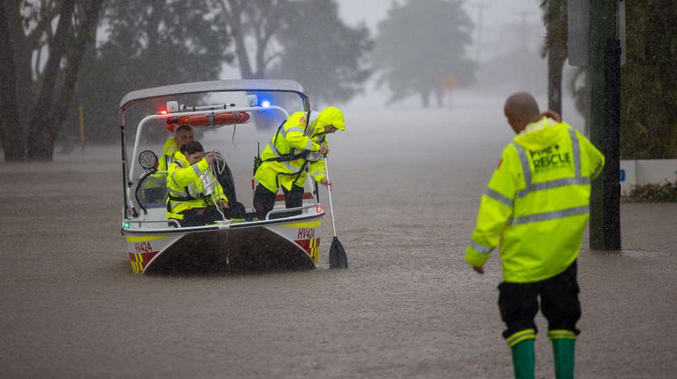 epaselect epa12124624 NSW Fire Rescue personnel assist an elderly resident during flooding in Port Macquarie, New South Wales, Australia, 22 May 2025. A slow-moving trough is dumping rain along the east coast of Australia, leaving thousands of people stranded.  EPA/Lindsay Moller AUSTRALIA AND NEW ZEALAND OUT