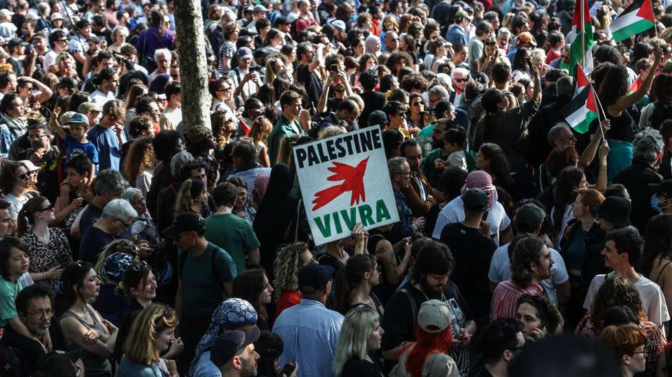epa12166787 A demonstrator holds a placard reading 'Palestine will live' during a solidarity rally for Gaza and Palestine at the Place de la Republique in Paris, France, 09 June 2025. La France Insoumise organizes a protest against Israel’s interception of the Freedom Flotilla and the arrest of 12 humanitarians, including French MEP Rima Hassan and climate activist Greta Thunberg. The FFC stated its Gaza-bound Madleen ship, carrying a small shipment of humanitarian aid, was forcibly intercepted by the Israeli military in international waters on 09 June 2025.  EPA/MOHAMMED BADRA