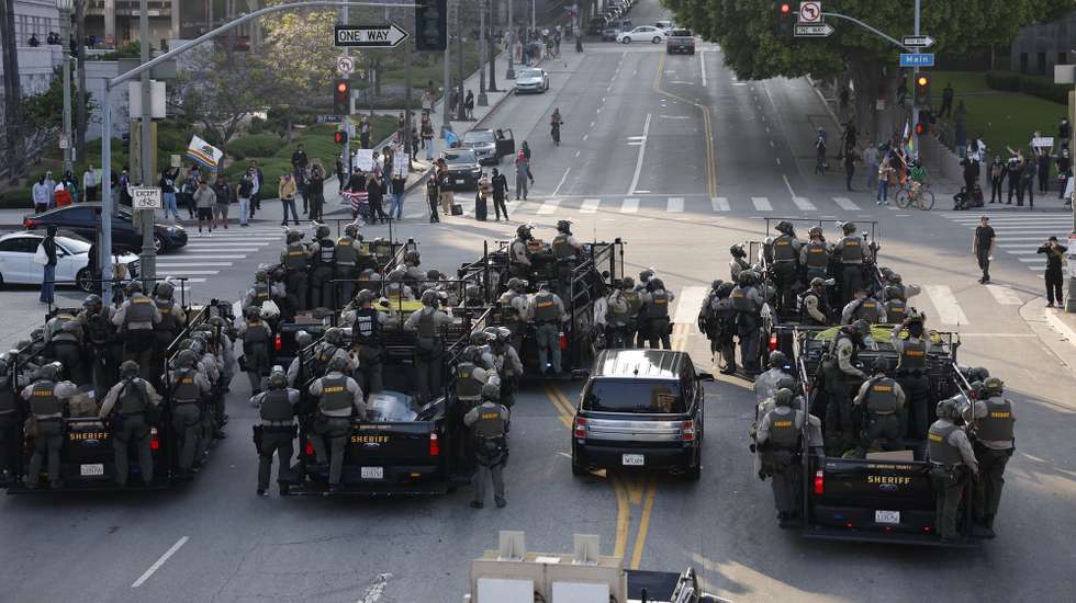 epa12167309 Police fill the street as they face off with protesters in Los Angeles, California, USA, 09 June 2025. Approximately 2,000 National Guard troops were deployed on 08 June in Los Angeles by US President Donald Trump, though the state of California had not requested any additional assistance, and protests have continued against the Trump administration's immigration enforcement raids over the last couple of days.  EPA/CAROLINE BREHMAN