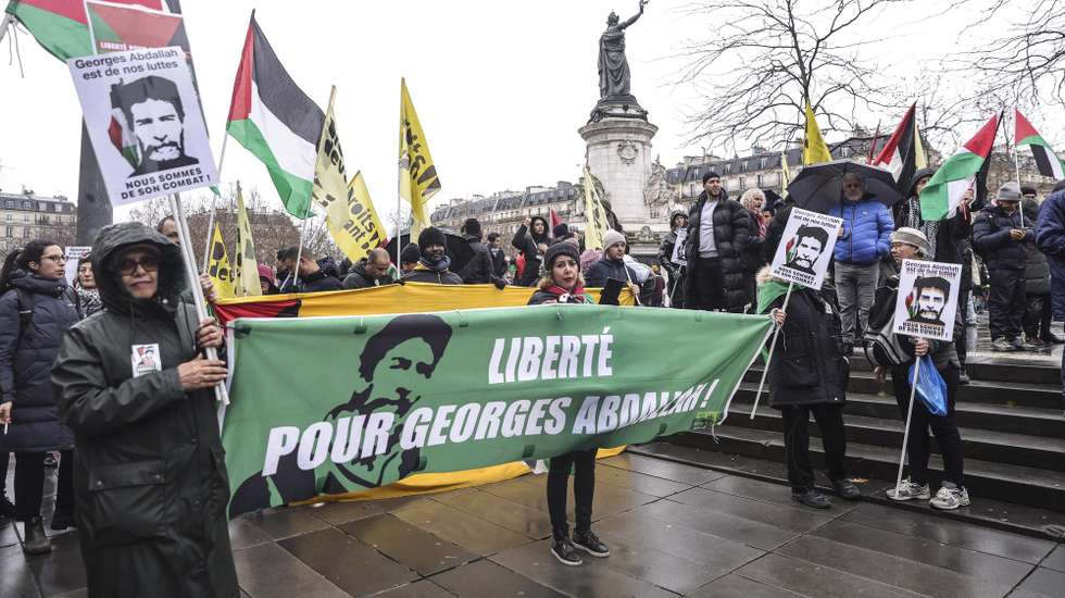 epa11788701 People participate in a demonstration in support of Lebanese prisoner Georges Ibrahim Abdallah in Paris, France, 21 December 2024. In November 2024, a French court ordered Abdallah's release after he had been imprisoned in France for 40 years and has been eligible to apply for parole since 1999. Abdallah, a former leader of the Lebanese Armed Revolutionary Factions (LARF), was sentenced to life in prison for his involvement in the killing of two foreign diplomats in 1982.  EPA/TERESA SUAREZ