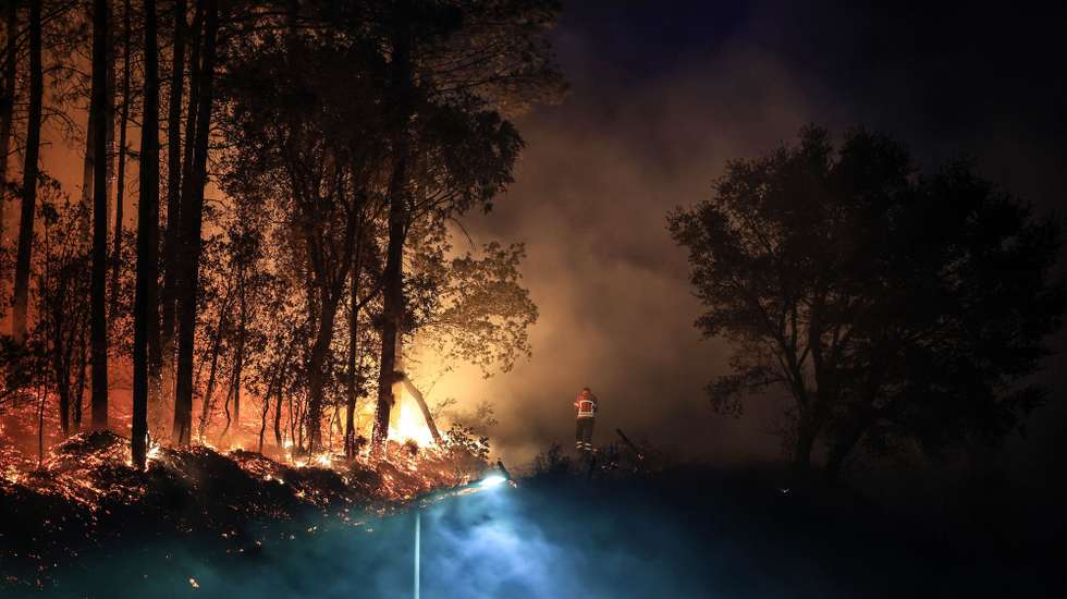 epa11610955 A firefighter observes the ongoing fire in Talhadas, Sever do Vouga, Aveiro, 18 September 2024. Seven people have died, and 40 have been injured, two seriously, in the fires that have been raging since Sunday in the northern and central regions of the country, in the districts of Aveiro, Porto, Vila Real, and Viseu, destroying dozens of houses and forcing roads and motorways to be cut.  EPA/ESTELA SILVA