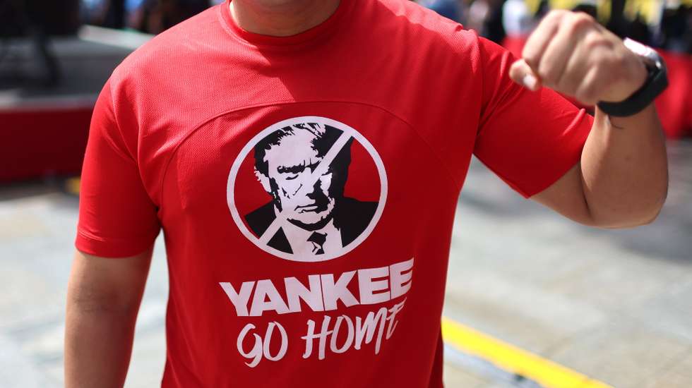 epa12334646 A person wears a T-shirt with Donald Trump's image during the enlistment day in Caracas, Venezuela, 29 August 2025. Venezuela's National Electoral Council called on citizens to enlist in light of tensions with the United States. The US deployed war ships near Venezuelan waters to combat drug trafficking.  EPA/MIGUEL GUTIERREZ