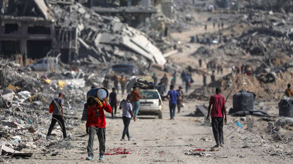 epa12447094 Internally displaced Palestinians walk along a street among the rubble of destroyed buildings amid a ceasefire between Israel and Hamas, in Gaza City, 11 October 2025. US President Donald Trump announced that Israel and Hamas have agreed to the first phase of a Gaza peace plan. The deal involves the release of Israeli hostages and Palestinian prisoners, the withdrawal of Israeli forces, and the delivery of humanitarian aid to Gaza.  EPA/MOHAMMED SABER