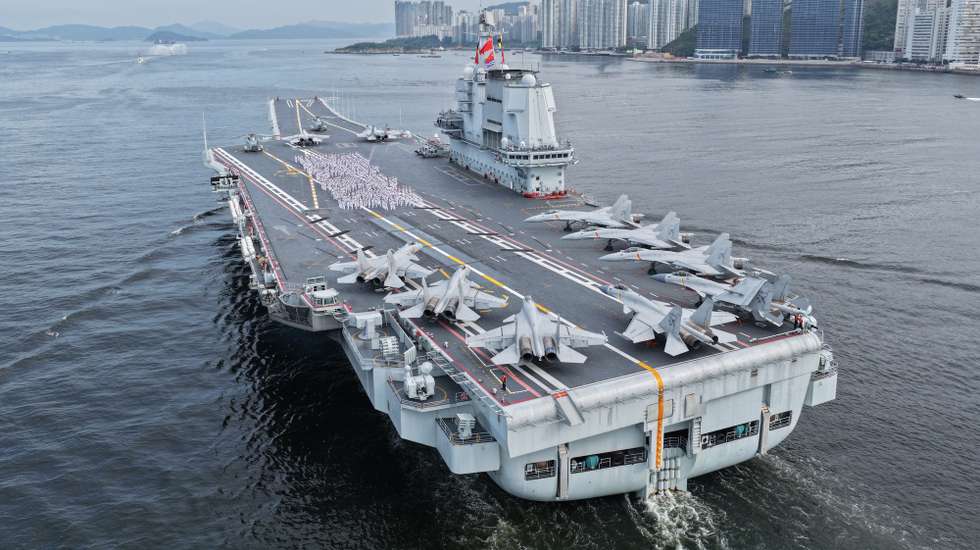 epa12211828 Officers and soldiers spelling out Chinese characters 'secure country, sweet home' on aircraft carrier Shandong's flight deck in Hong Kong waters, China, 03 July 2025. A fleet of the Chinese People's Liberation Army (PLA) Navy led by the aircraft carrier Shandong arrived in the Hong Kong Special Administrative Region (HKSAR) on 03 July morning, kicking off a five-day visit. The aircraft carrier and the Yan'an missile destroyer were anchored near the west end of the Victoria Harbor, while the Zhanjiang missile destroyer and the Yuncheng missile frigate docked at the PLA Hong Kong Garrison's naval base in Stonecutters Island. This is the Shandong's first visit to Hong Kong. From Friday to Sunday, the Shandong, the Zhanjiang and the Yuncheng will host open tours, lectures, drill demonstrations and other exchange activities.  EPA/XINHUA / LIU FANG CHINA OUT / UK AND IRELAND OUT  /       MANDATORY CREDIT EDITORIAL USE ONLY