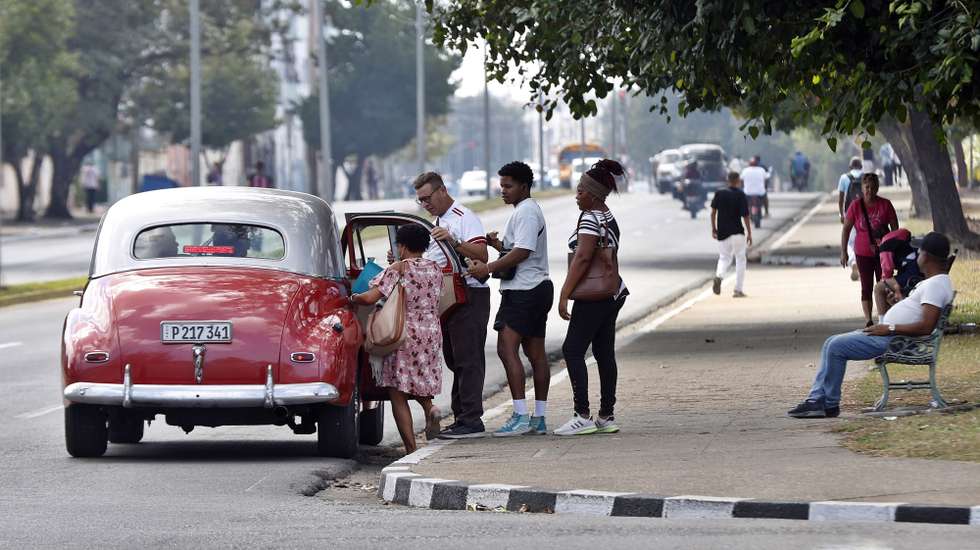 epa12761960 People board a vehicle in Havana, Cuba, 19 February 2026 (issued 20 February 2026). Fuel shortages have emptied the island's streets, leaving those who provide transportation services in a state of total uncertainty.  EPA/ERNESTO MASTRASCUSA