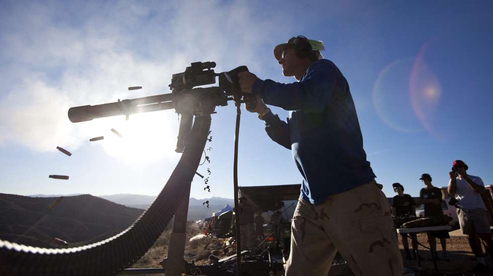 epa03527721 YEARENDER 2012 DECEMBER
(01/22) Dave Lansky fires a Minigun, which shoots 50 rounds a second, at the Big Sandy Machine Gun Shoot outside Wikieup, Arizona, USA, 19 October 2012. Twice a year, the Big Sandy lures gun enthusiasts to the Sonoran Desert for a weekend of firing heavy weaponry.  EPA/JIM LO SCALZO PLEASE REFER TO ADVISORY NOTICE epa03478716 FOR FULL FEATURE TEXT