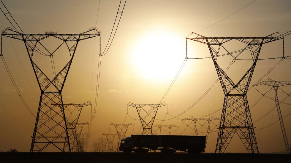 epa07064585 A long haul truck drives under powerlines while traveling on the N3 highway near Johannesburg, South Africa, 02 October 2018. The road is a major highway for trucks hauling goods from the major port city of Durban to the financial hub of the country, Johannesburg. Trucking is a major business in the country as millions of tons of goods has to be ferried from the ports of Durban and Cape Town inland.  EPA/KIM LUDBROOK