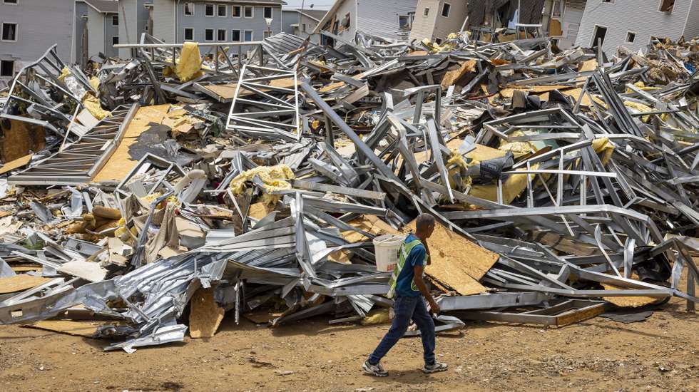 epaselect epa13180936 A man walks past the rubble of homes damaged by earthquakes in Catia La Mar, Venezuela, 17 August 2026 (issued 20 August 2026). Amid the ruins of buildings and the passage of machinery clearing away the rubble, nearly two months after the earthquakes of June 24, daily life has found its way back among hundreds of tents in the Venezuelan state of La Guaira, where precarious conditions and resilience prevail.  EPA/Miguel Gutierrez