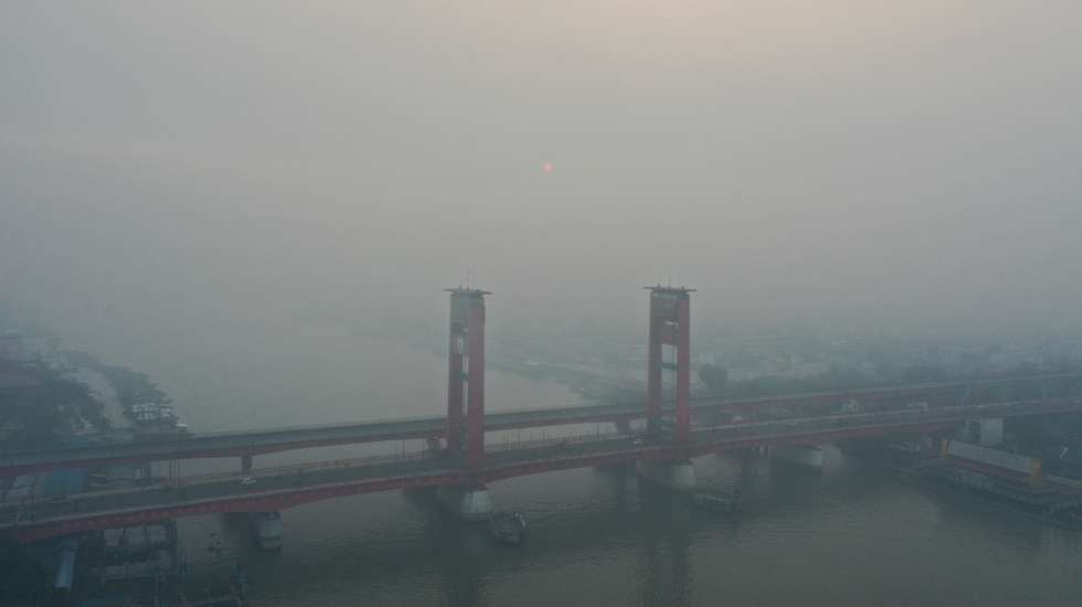 epa13216250 An aerial view taken with a drone shows thick haze from wildfires shrouding Ampera Bridge in Palembang, South Sumatra, Indonesia, 06 September 2026. Wildfires in Sumatra and Kalimantan, intensified by strong El Nino conditions, have generated widespread smoke haze that has spread across the region, causing hazardous air quality in neighboring Malaysia, Singapore and the Philippines.  EPA/MAST IRHAM