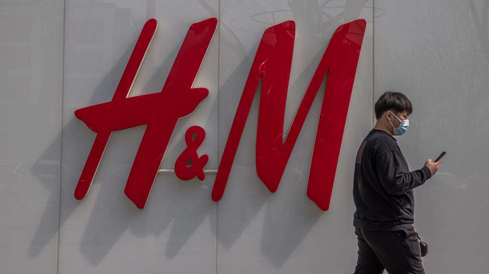 epa09095350 A man walks past an H&amp;M store in a shopping area of Sanlitun in Beijing, China, 25 March 2021. International clothing brands H&amp;M, Nike and Adidas face backlash in China for refusing to buy Xinjiang cotton over claims of forced labor and genocide in the region.  EPA/ROMAN PILIPEY