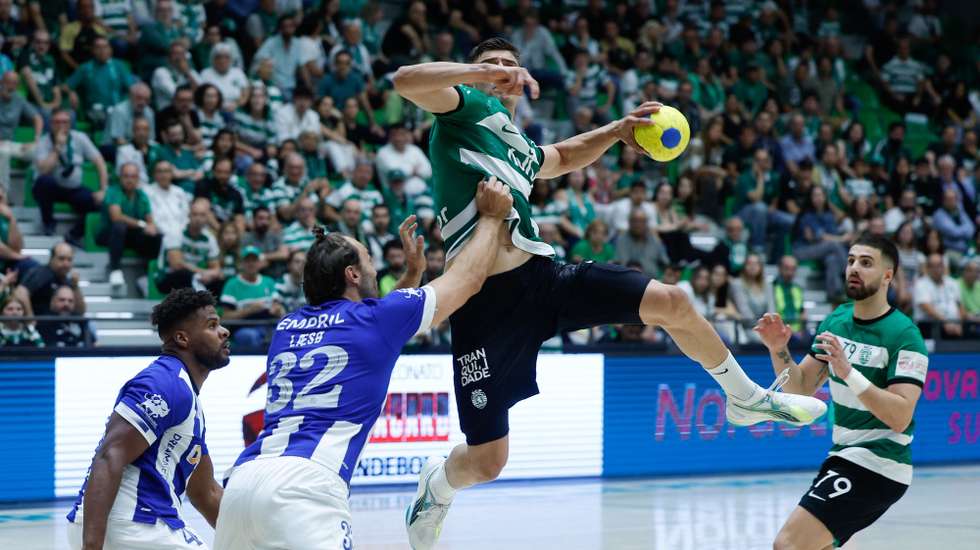 O jogador do Sporting, Natan Suarez (C), disputa a bola contra o jogador do FC Porto, Christensen (2-E), durante o jogo da fase final do campeonato nacional de andebol, disputado no Pavilhão João Rocha, em Lisboa, 25 de maio de 2024. ANTÓNIO PEDRO SANTOS/LUSA