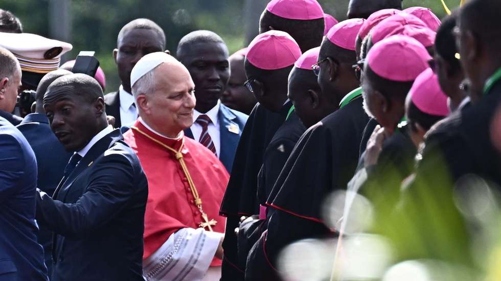 epa12891910 Pope Leo XIV is welcomed by officials upon his arrival at Yaounde Nsimalen International Airport in Yaounde, Cameroon, 15 April 2026. The pontiff is on the second leg of an 11-day apostolic journey to Africa.  EPA/LUCA ZENNARO