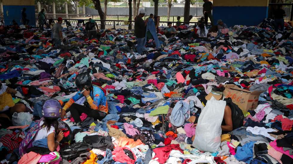 epa13088071 People search through clothing at the La Juanita sports center after it was damaged during the earthquakes in La Guaira, Venezuela, 04 July 2026. Two earthquakes of magnitude 7.2 and 7.5 struck Venezuela on 24 June, killing at least  2,954 people and injuring at least 16,592 people, according to Parliament Speaker Jorge Rodriguez.  EPA/RAUL MARTINEZ