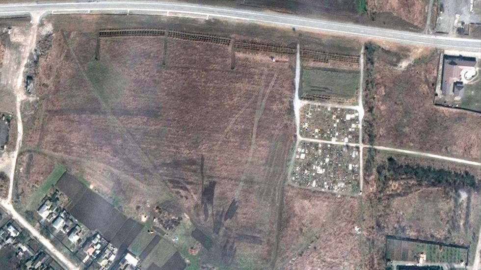 epa09900942 A handout satellite image made available by Maxar Technologies claims to show a mass grave site adjacent to an existing village cemetery on the northwestern edge of Manhush, some 20 kilometers west of Mariupol, Ukraine, 03 April 2022 (issued 21 April 2022). Maxar has reviewed satellite images from mid-March through mid-April, and indicate that the expansion of the new set of graves began between 23 to 26 March 2022 and continued to expand. The graves are aligned in four sections of linear rows (measuring approximately 85 meters per section) and contain more than 200 new graves, Maxar states.  EPA/MAXAR TECHNOLOGIES HANDOUT -- MANDATORY CREDIT: SATELLITE IMAGE 2022 MAXAR TECHNOLOGIES -- THE WATERMARK MAY NOT BE REMOVED/CROPPED -- HANDOUT EDITORIAL USE ONLY/NO SALES