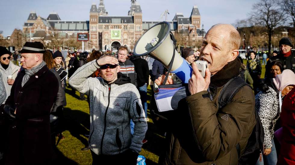 epa08977628 Protesters on the Museumplein at Museumplein, Amsterdam, Netherlands, 31 January 2021. According to media reports, Museumplein, is once again, classified as a 'security risk area', giving police officers the right to check and search anybody in that area without a cause. The police are extra vigilant about demonstrations and riots on Museumplein, after things got out of hand a week earlier.  EPA/ANP09