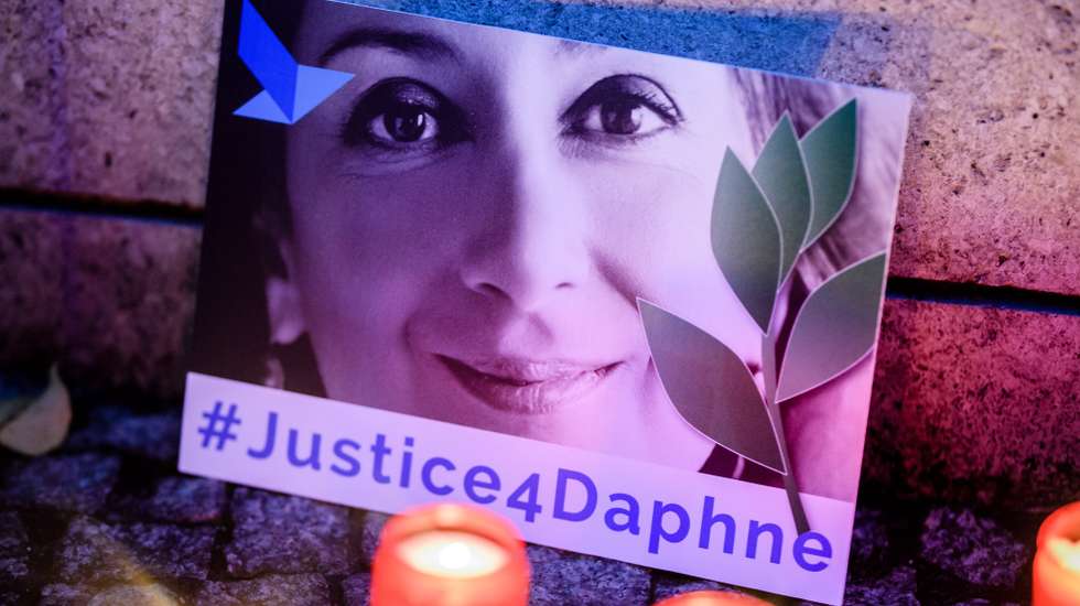 epa09031963 (FILE) - 'Justice four Daphne' is written on a cardboard showing a photo of Daphne Caruana Galizia, during a picket in front of the Maltese embassy for murdered journalist Daphne Caruana Galizia in Berlin, Germany, 16 October 2019 (reissued 23 February 2021). More than three years after the murder of journalist Daphne Caruana Galizia in Malta, a court has sentenced one of three defendants to 15 years in prison, after he admitted to the killing, media in Malta reported. Maltese journalist Daphne Caruana Galizia was killed on 16 October 2017 in Malta, while investigating the Panama Papers case.  EPA/CLEMENS BILAN *** Local Caption *** 55553937