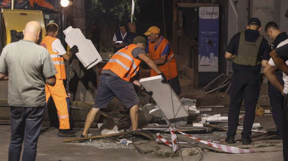 epa13116502 Communal workers clean debris at the site of a Russian strike on a residential area in Odesa, Ukraine, late 16 July 2026 (issued on 17 July 2026), amid the Russian invasion. At least two people died, and 10 others were injured, including children, after the Russian overnight attack on Odesa, according to Oleg Kiper, the head of the Odesa regional military administration.  EPA/IGOR MASLOV