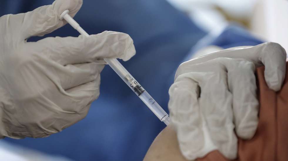 epa08967740 A health worker receives a dose of Covishield Covid-19 vaccine at Yangon General Hospital, in Yangon, Myanmar, 27 January 2021. Myanmar began its vaccination drive after receiving 1,5 million doses of Covishield vaccine from neighboring India.  EPA/LYNN BO BO