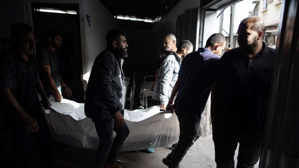epa11372942 Palestinians carry a body after an Israeli army raid on a camp at an area designated for displaced people in Rafah, southern Gaza Strip, 27 May 2024. At least 40 people were killed after Israeli airstrikes hit an area in Rafah designated for the displaced, the Palestinian Civil Defense said. More than 35,000 Palestinians and over 1,400 Israelis have been killed, according to the Palestinian Health Ministry and the Israel Defense Forces (IDF), since Hamas militants launched an attack against Israel from the Gaza Strip on 07 October 2023, and the Israeli operations in Gaza and the West Bank which followed it.  EPA/HAITHAM IMAD