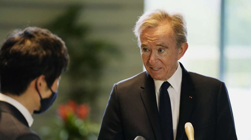 epa09922193 LVMH Moet Hennessy Louis Vuitton CEO Bernard Arnault (R) speaks to the press following his meeting with Japanese Chief Cabinet Secretary Hirokazu Matsuno (not pictured) at the Prime Minister's Office in Tokyo, Japan, 02 May 2022.  EPA/Hiro Komae / POOL