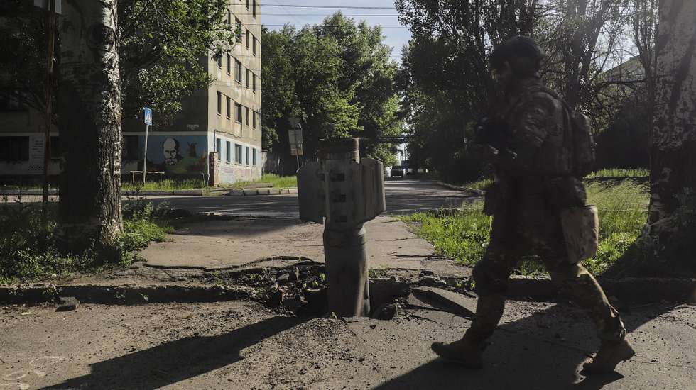 epa09992798 A Ukrainian soldier walks past a part of a rocket near the front line in the city of Severodonetsk, Luhansk region, Ukraine, 02 June 2022, where heavy fighting took place in the last few days. While addressing the Luxembourg parliament, Ukrainian President Volodymyr Zelensky said that as of 02 June, about 20 percent of Ukraine is under the control of Russia. Russian troops on 24 February entered Ukrainian territory, starting a conflict that has provoked destruction and a humanitarian crisis.  EPA/STR