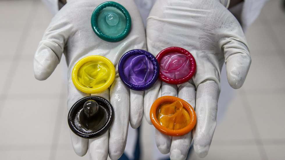 epa04613963 A picture made available on 11 February 2015 shows a worker holding a variety of colored condoms at the Karex condom factory in Port Klang, Malaysia, 17 January 2015. Karex is one of the world's largest maker of condoms with an anual output of some four billion pieces. The family run Malaysian business with manufacturing facilities across Pontian, Johor, Port Klang Selangor and also in Hat Yai, Thailand, has a workforce of 2,000 employees and utilises the local rubber production for their product. The company continues to explore new designs, changing shapes, sizes, textures, colors, flavors and fragrances, including chocolate, marijuana and durian flavored condoms. A third of the production goes to the United Nations and other international organizations.  The company plans to increase production aiming for six billion pieces annually by end of 2015. The company claims that more than one condom in ten manufactured in the world, comes from Malaysia.  EPA/AZHAR RAHIM