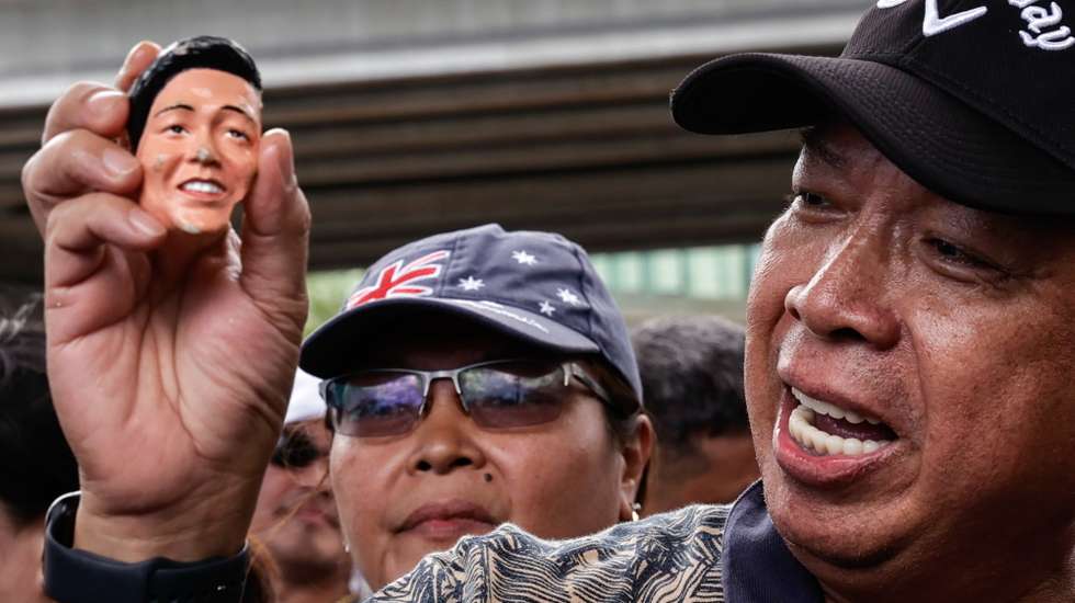 epaselect epa11954797 A supporter of former Philippine President Rodrigo Duterte holds and mocks a bobblehead doll of President Ferdinand Marcos Jr., during a protest outside the Villamor Airbase Air Force camp where Duterte was arrested, following his arrival in Pasay City, Metro Manila, Philippines 11 March 2025. Duterte was arrested 11 March in Metro Manila following the issuance of a warrant from the International Criminal Court (ICC), which is investigating his drug war campaign that allegedly resulted in thousands of cases of extrajudicial killings during his term as Philippine president.  EPA/ROLEX DELA PENA