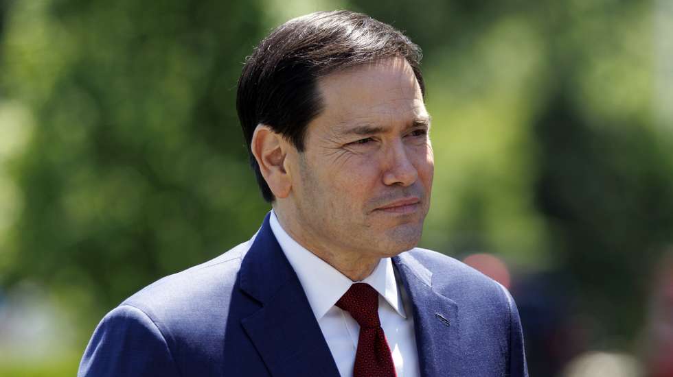 epa12951312 US Secretary of State Marco Rubio watches as US President Donald Trump talks to the media before leaving the South Lawn of the White House, Washington, DC, USA, 12 May 2026. President Trump is leaving the US to visit China where he will meet with President Xi in Beijing.  EPA/WILL OLIVER