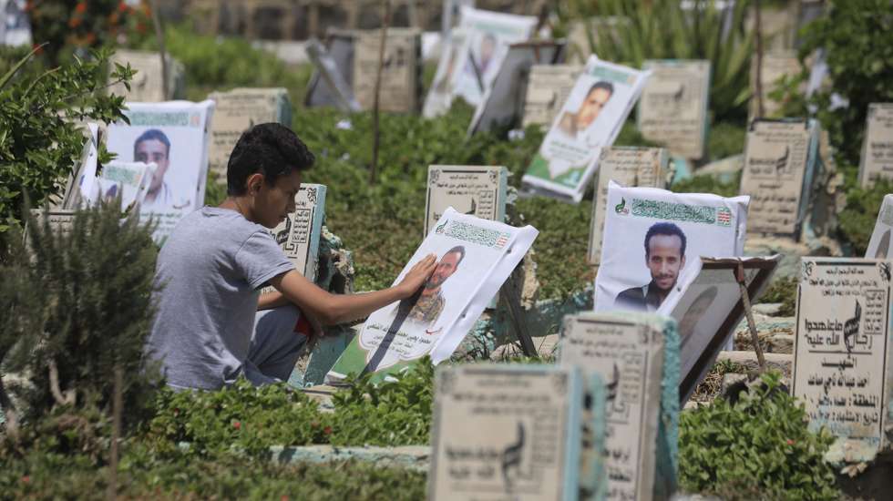 epa13277436 A person cleans the portrait on the grave of a relative at a cemetery dedicated to those who were killed in Yemen's prolonged conflict, in Sana'a, Yemen, 02 October 2026. Yemen has been at risk of rupture again amid escalating fighting along the country’s Red Sea coastal areas near the Bab al-Mandeb Strait between Saudi-backed government forces and the Houthis, who have consolidated their grip over large parts of northern Yemen, including the capital Sana'a, since 2015.  EPA/YAHYA ARHAB