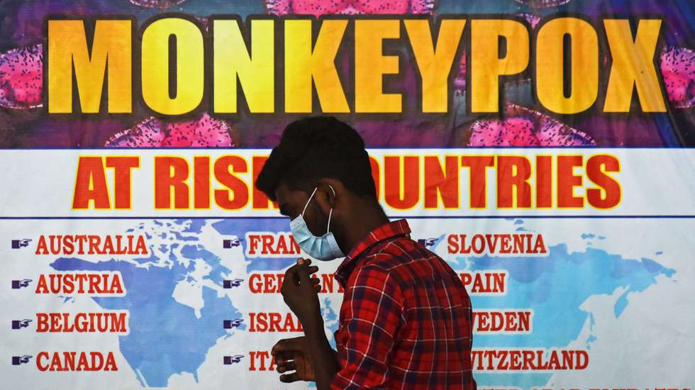 epa10334196 (FILE) - An Indian health worker walks in front of a list of high-risk countries for the Monkeypox virus, at Chennai International Airport, in Chennai, India, 16 July 2022 (reissued 28 November 2022). The World Health Organization (WHO) in a statement on 28 November 2022 said it "will begin using a new preferred term mpox as a synonym for monkeypox" simultaneously for one year until the term 'monkeypox' is phased out. The decsion was taken after consultations with global experts as "racist and stigmatizing language online, in other settings and in some communities was observed and reported to WHO."  EPA/IDREES MOHAMMED