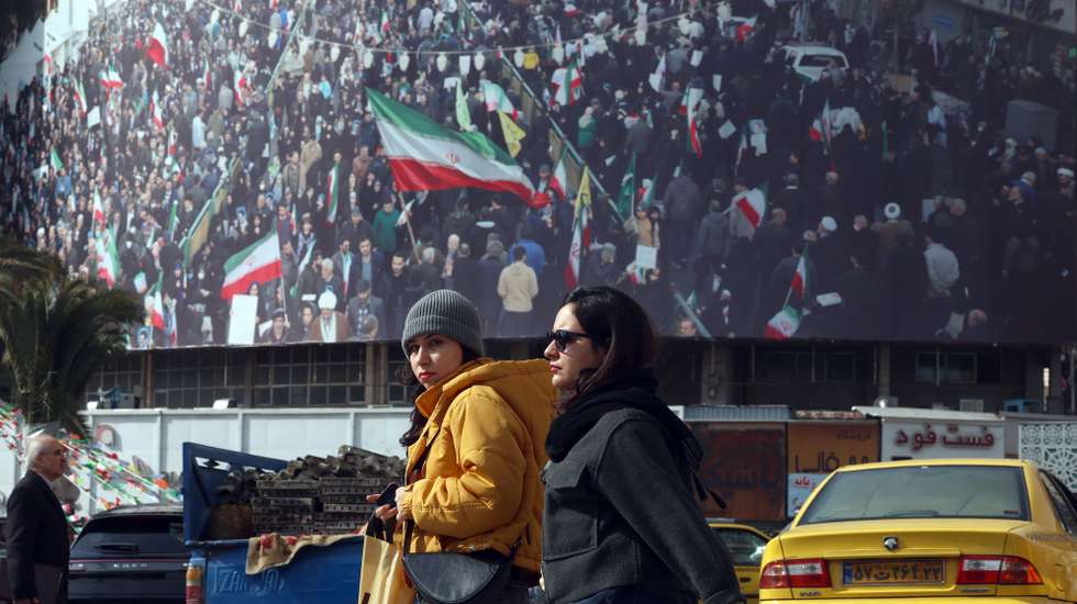 epaselect epa12699976 Iranians walk in a street in Tehran, Iran, 02 February 2026. Following the US President Donald Trump renewed threats of military action against Iran, Iranian supreme leader Ayatollah Ali Khamenei on 01 February 2026 warned that any military attack by the United States would spark a 'regional war'.  EPA/ABEDIN TAHERKENAREH
