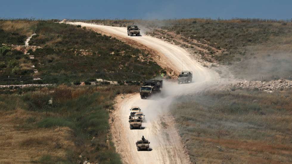 epa13046528 Israeli military vehicles maneuver on the Lebanese side of the border, as seen from the Upper Galilee in northern Israel, 18 June 2026.  EPA/ATEF SAFADI