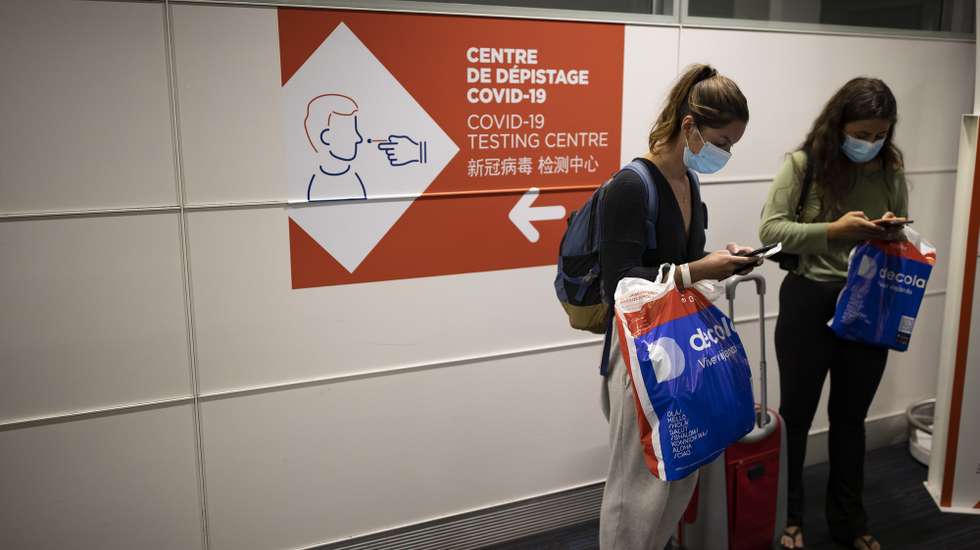 epa09158056 Passengers check their telephones next to a sign indicating the way to a sanitary control point for passengers arriving from countries listed as red zones, in Roissy Charles de Gaulle airport in Roissy near Paris, France, 25 April 2021. Passengers arriving in France from Brazil, Chile, Argentina, South Africa, India and Guyana must submit to a Covid19 antigenic test and follow a 10 day quarantine at home, to curb the spread of Covid19 coronavirus variants.  EPA/IAN LANGSDON /POOL