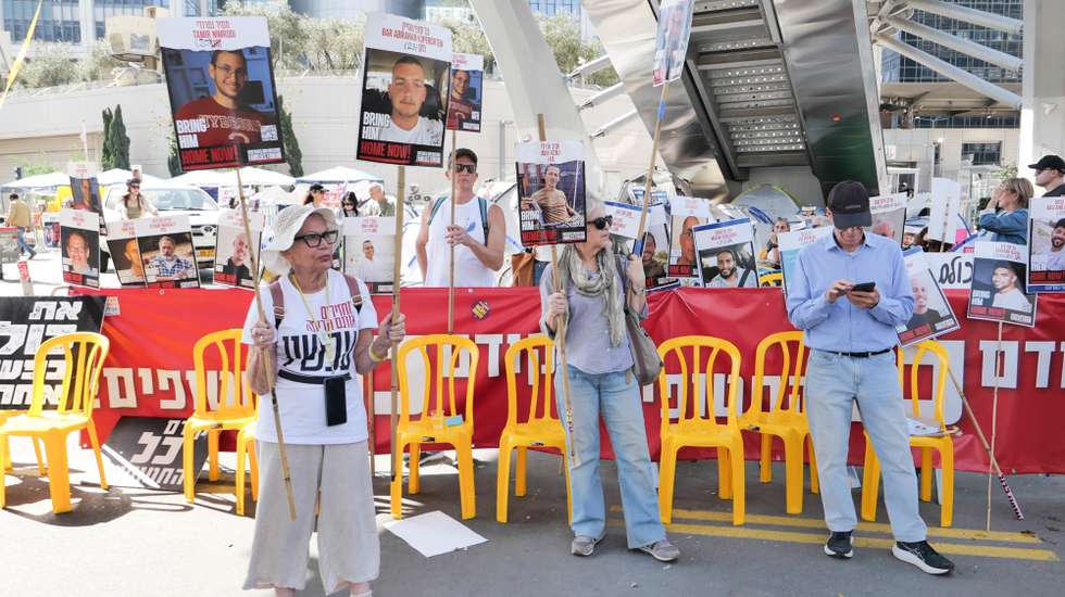 epa11963416 Families of Israeli hostages held by Hamas in Gaza, and their supporters, hold signs outside one of the entrances to the Kirya military headquarters during a protest calling for the completion of the hostage deal between Israel and Hamas, in Tel Aviv, Israel, 14 March 2025. According to the Israeli army (IDF) spokesperson, around 59 Israeli hostages remain in captivity in the Gaza Strip, including the bodies of at least 35 confirmed dead.  EPA/ABIR SULTAN