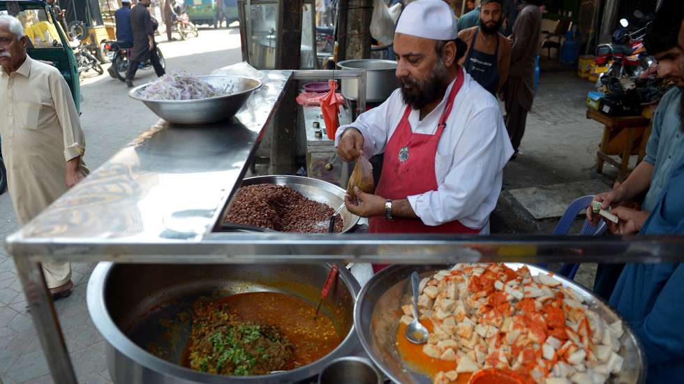 epa12455097 A Pakistani chef prepares meals in a restaurant a day before World Food Day in Peshawar, Pakistan, 15 October 2025. World Food Day is celebrated every year on 16 October to commemorate the founding of the Food and Agriculture Organization of the United Nations (FAO) in 1945. The day aims to raise public awareness about the plight of the world's hungry and malnourished and to encourage global action against hunger. The official theme for World Food Day 2025 is 'Hand in Hand for Better Foods and a Better Future.'  EPA/BILAWAL ARBAB