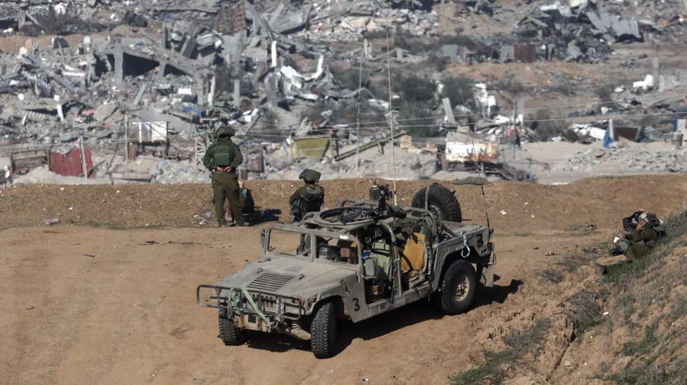 epa11072409 (FILE) - epa11047745 Israeli army soldiers stand guard at a position near the Israeli-Gaza border, overlooking the Shujaiya neighborhood in the Gaza Strip, in southern Israel, 29 December 2023.(Issued 12 January 2024). Upcoming 14 January 2024 will mark the one-hundredth day since Hamas' attack on Israel. More than 23,600 Palestinians and at least 1,300 Israelis have been killed, according to the Palestinian Health Ministry and the Israel Defense Forces (IDF), since Hamas militants launched an attack against Israel from the Gaza Strip on 07 October, and the Israeli operations in Gaza and the West Bank which followed it.  EPA/ATEF SAFADI