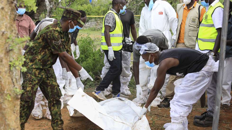 epa10588062 Kenyan homicide detectives and forensic experts from the Directorate of Criminal Investigations (DCI), examine exhumed bodies from several shallow mass graves of suspected members of a Christian cult after starving themselves to death, after allegedly being told by their controversial preacher Paul Mackenzie that they would go to heaven if they starved themselves to death, in the coastal Shakahola forest, in Kilifi, Kenya, 23 April 2023. According to the Police, 18 more bodies were exhumed on 23 April bringing the tally of bodies recovered to at 39.  EPA/STR
