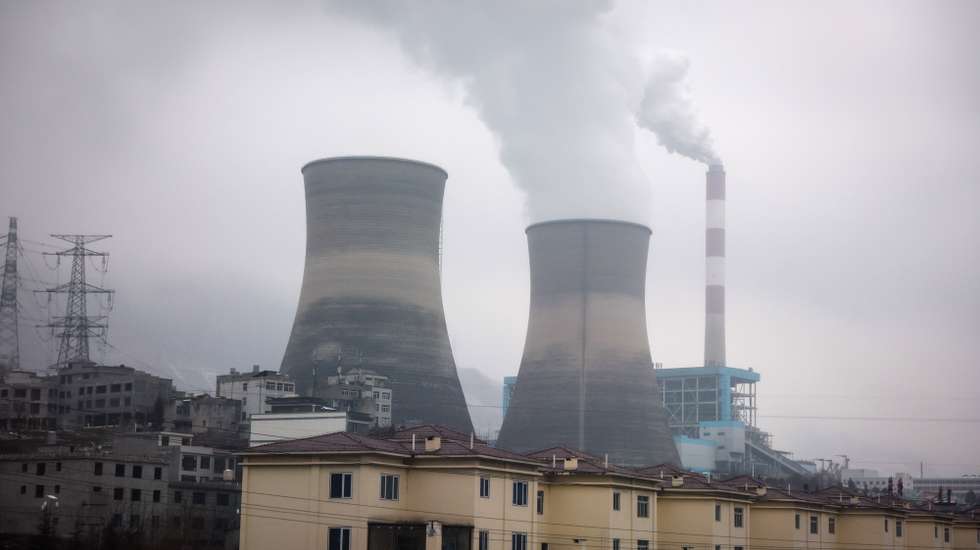 epa11097908 A coal power plant along the mountains in Tangfang Town of Zhenxiong County, Yunnan province southwest of China, 23 January 2024. Chinese state media reported at least 20 dead and 24 missing after a landslide hit Liangshui Village in China's southwest province of Yunnan early morning on 22 January, with 18 homes buried and more than 500 people evacuated.  EPA/MARK R. CRISTINO