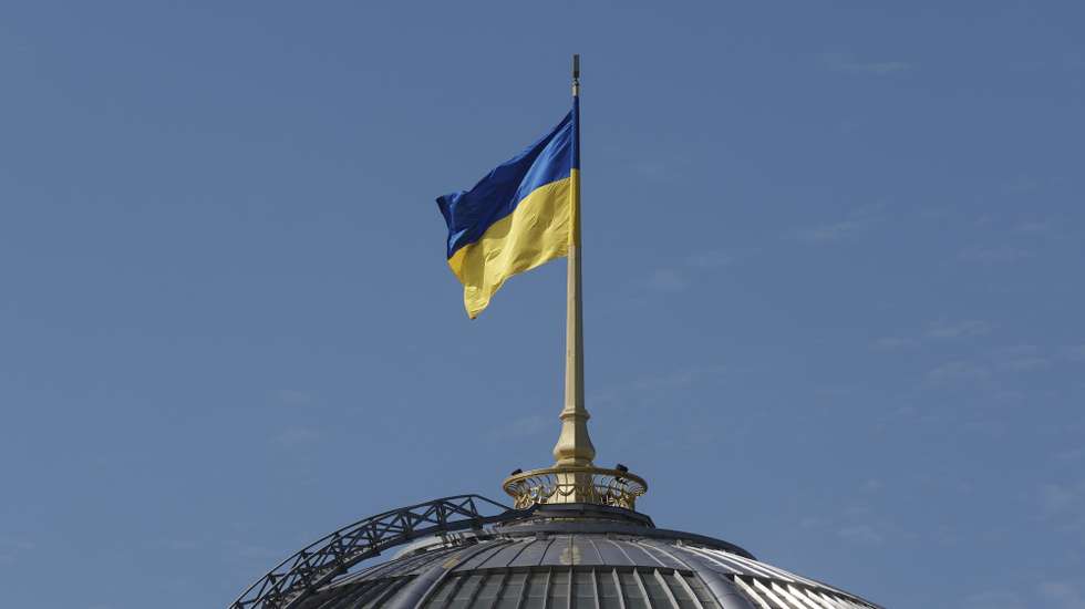 epa11561539 The Ukrainian national flag waves on top of the Verkhovna Rada (Parliament) building during an official visit by India's Prime Minister Modi, in Kyiv, Ukraine, 23 August 2024. The Indian prime minister arrived in Ukraine to meet with top Ukrainian officials amid the ongoing Russian invasion.  EPA/SERGEY DOLZHENKO