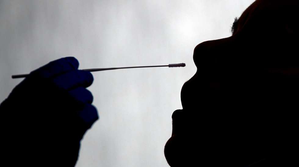 epaselect epa08854475 An employee of Barcelona's food wholesale market undergoes a swab sample collection for a PCR Covid-19 test in Barcelona, Spain, 01 December 2020. Barcelona's food wholesale market will run coronavirus tests to all 7,500 employees to 'stop coronavirus and not the economy'.  EPA/Alejandro Garcia
