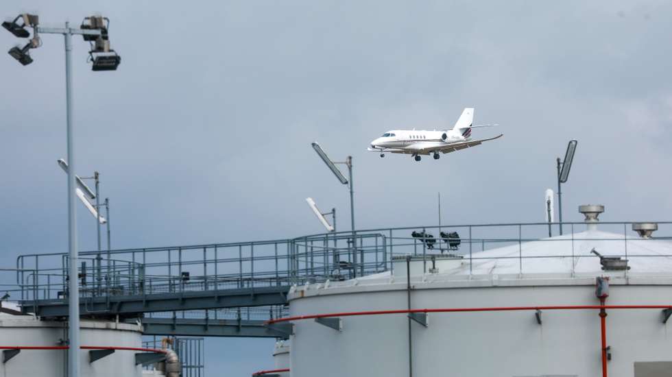 epa12893510 Aircraft pass behind kerosene storage facilities at Liege Airport in Liege, Belgium, 16 April 2026. Europe's aviation sector faces growing risks of jet fuel shortages as the ongoing conflict involving Iran disrupts supplies through the Strait of Hormuz, a key global oil transit route, with airlines warning of shortages within weeks and the European Union preparing emergency measures ahead of the summer travel season.  EPA/Olivier Hoslet